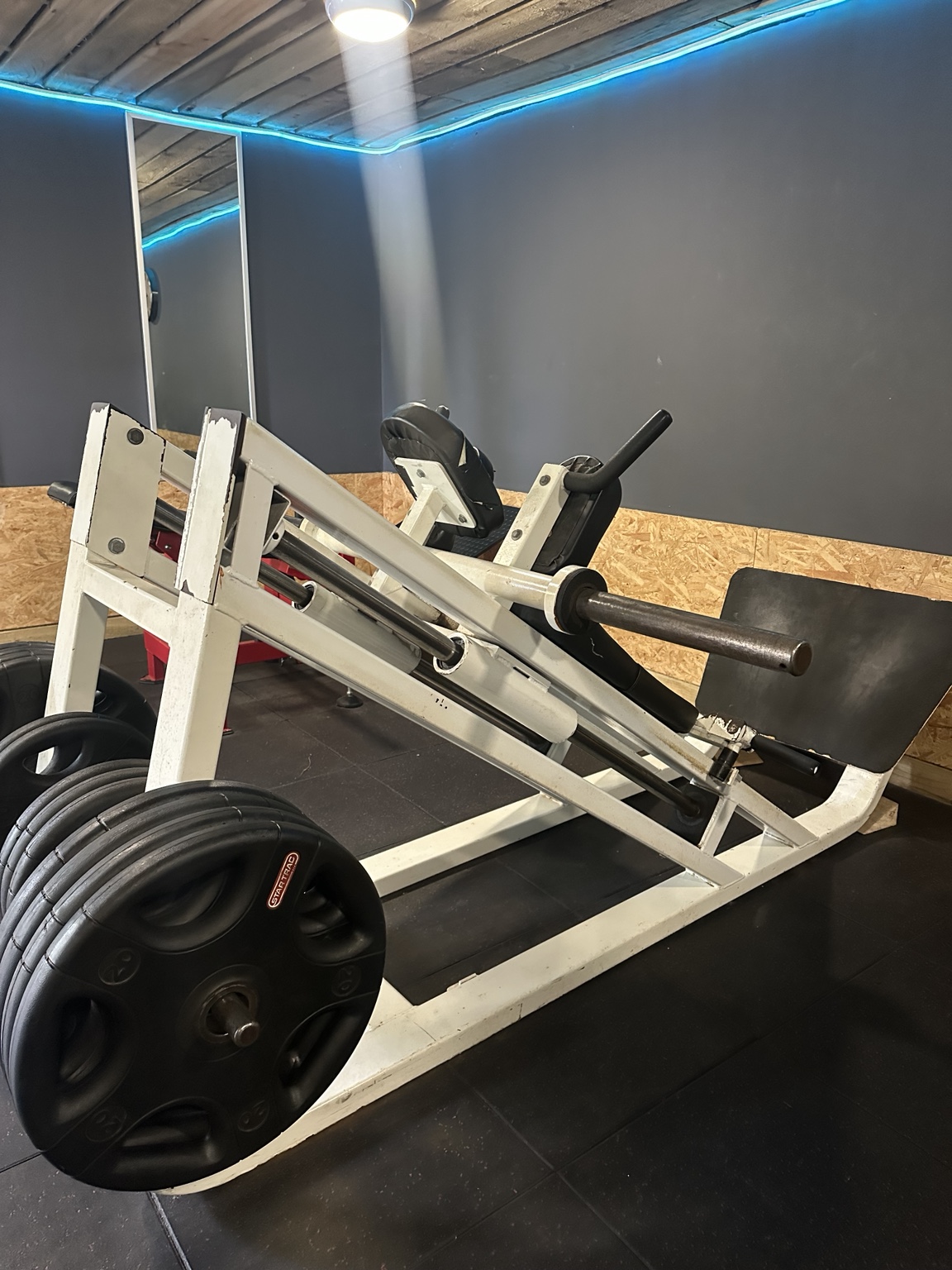 Urban Fitness plate-loaded leg press with iron weight plates