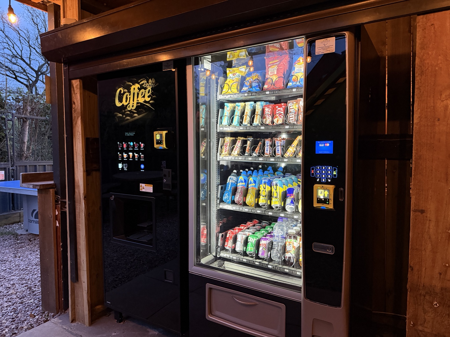 Coffee vending machine beside the cold drinks and snack machine